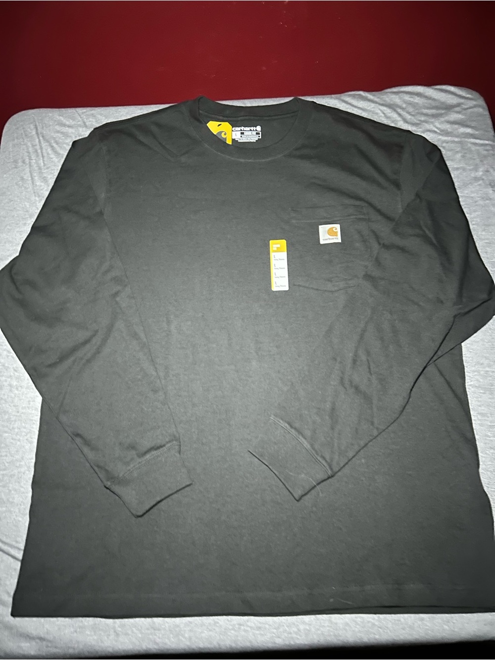 Carhartt Long Sleeve Pocket Tee in Dark Black with Yellow Logo Tag
